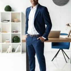 Handsome cheerful african american executive business man at the workspace office