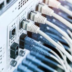 Fiber Optic cables connected to an optic ports and Network cables connected to ethernet ports