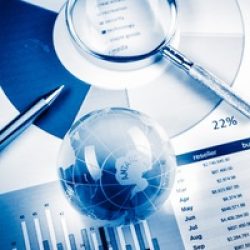 Business Data Analyzing, with magnifying glass and other on the desk.